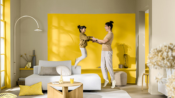 Living room with yellow feature wall and white sofa